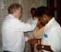 Roger praying for those recently baptised