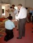 Roger praying for a man on 60th birthday