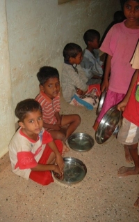 Photograph of some children eating in the orphanage
